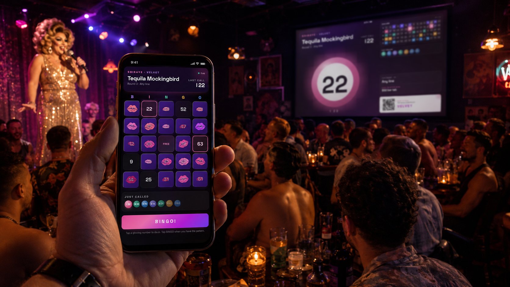 A sequined drag queen hosting bingo from a lit stage while a packed room plays along — a player up front holding his phone with his daubed Soiraye bingo card, the latest ball and the same card mirrored on the bar's big screen.